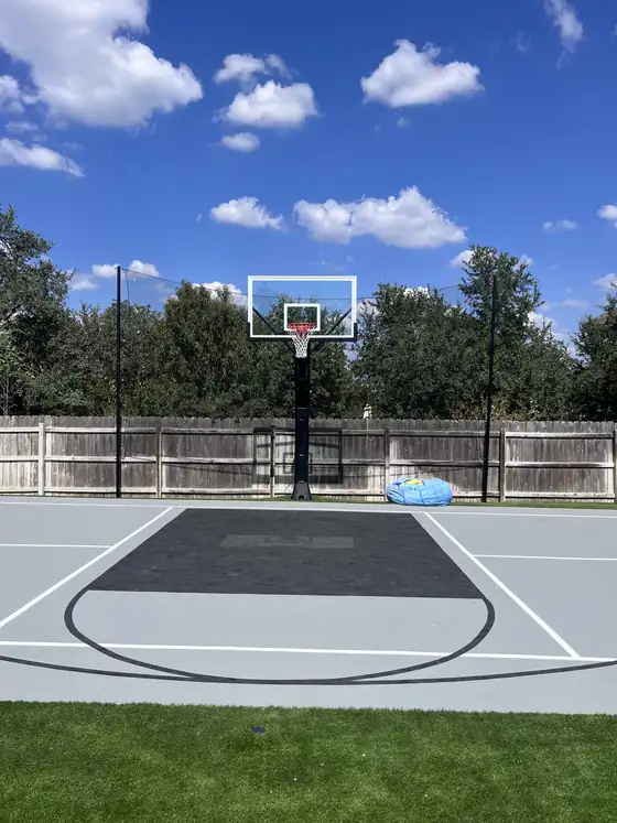 Backyard basketball court with hoop and dark painted key