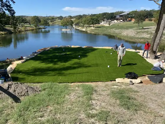 Putting green in a lakefront backyard